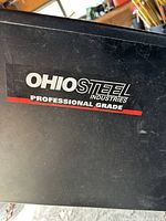 Close-up of OHIO STEEL Industries professional grade decal on black metal surface