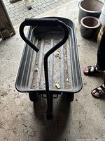 Front view showing padded handle and black plastic container