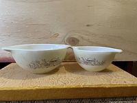 Front view of both Pyrex CorningWare bowls side by side showing size difference and design.