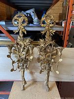 Overview of pair of gilt wooden wall sconces displayed side by side