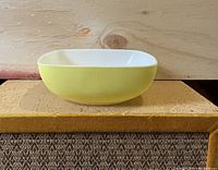 Side view of yellow Pyrex CorningWare bowl showing bowl's shape and size