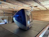 Side view showing the translucent Indigo Blue plastic casing and built-in CRT screen.