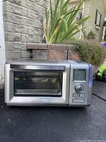 Front view of stainless steel Cuisinart steam convection oven with glass door and control panel on the right.