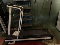 Full side view of the Weslo Cadence treadmill showing the treadmill belt and metal frame, located in a basement setting.