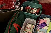 Photo of bins and tote filled with assorted ribbons, bows, and green zippered roll wrap case