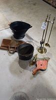Overall set showing kettle pot, fireplace tools on brass stand, coal hod, shovel, leather log carrier and bellows