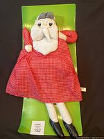 Full view of 24" old lady cloth doll on green poem backing