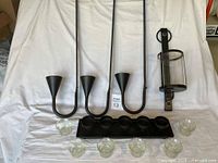 Full lot overview showing three IKEA sconces, hurricane sconce, tea-light base, six glass cups