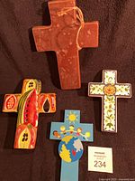 Group shot of four ceramic crosses
