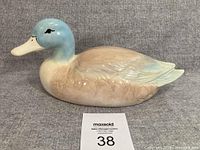 Left side view of glazed ceramic duck figurine