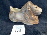 Side profile of lion planter showing overall form and condition