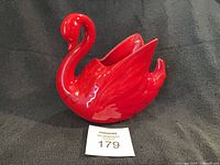 Full side view of red glazed ceramic swan planter