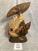 Full view of carved fish figurine on base