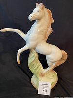 Front view of glazed porcelain rearing horse figurine