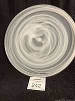 Front view of round swirl glass platter with swirl pattern, scale indicator
