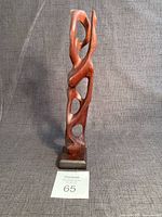 Full view of wood abstract figurine on base