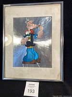 Front view of framed Popeye silver foil picture