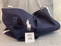 Full view of navy duffel showing Polo logo and overall design