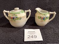 Creamer and sugar bowl front view with lot card
