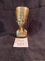 Front view of polished brass Nefertiti bust