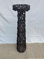 Full view of woven vine pedestal stand