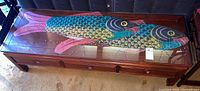 Full view of rectangular coffee table with glass top displaying colorful fish artwork underneath.