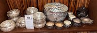 Overview of 15 vintage metal bowls and dishes with embossed floral and patterned design, largest approximately 7 inches wide.