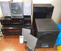 Full lot showing Sony stereo receiver, vertical load CD player, Monsoon black subwoofer, Monsoon satellite speakers, and extra components.