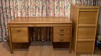 Full front view of wood veneer locking desk and 3-drawer oak file cabinet.