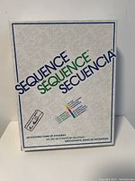 Photo of the Sequence board game outer box with multi-language logo and tagline