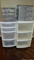 Photo showing four storage drawer units on wheels clustered together.