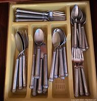 Tray holding mixed forks, knives and spoons in plastic insert
