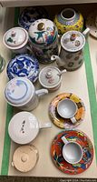 Overview of entire assortment including cups, saucers, mugs, teapot and jars