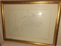 Frontal photo of the framed Picasso style print showing the woman resting on arms in gold frame.