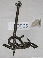 Full view of one wrought iron toilet paper holder with twisted branch design and mounting screws.