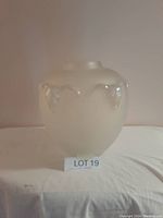 Front view of the frosted glass vase with raised steer heads visible around the widest point