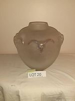 Front view of the frosted glass vase with steer head design and lot number.