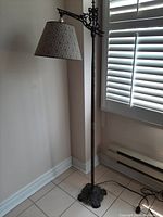 Full view of the floor lamp showing general structure, lampshade, and placement in room