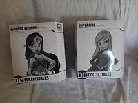 Front view of Wonder Woman and Supergirl boxed figures from DC Artists Alley by Chrissie Zullo.