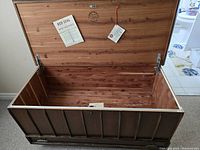 Open cedar chest showing cedar-lined interior and original Red Seal tags attached inside the lid.