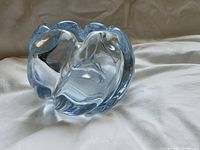 Top and angled view of the organic shaped ice blue clear glass vase showing the smooth contours and thickness of the glass.