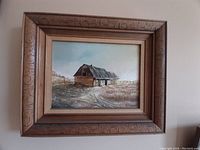 Framed oil painting titled "Old Barn" showing rustic barn and fencing with rural landscape background.