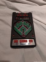 Front view of the Baseball 3 handheld game showing the printed baseball diamond, buttons, and control panel.