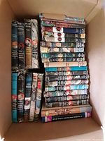 Box with hardcover Hardy Boys books and other classic boys' books stacked with visible dust jackets and wear