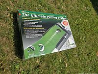 Box for The Ultimate Putting System, outdoor photo showing box front with product image and features.