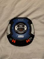 Top view of Panasonic Shockwave portable CD player Discman closed, showing buttons and blue-black color with silver side grips.
