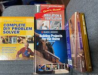Five home improvement books arranged on carpet showing front covers and spines, titles and authors visible