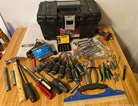 Full overview of assorted hand tools including hammer, screwdrivers, wrenches, pliers, Speed Out set, and toolbox