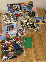 Overview photo showing all bagged LEGO pieces sorted by set with manuals and some minifigures visible