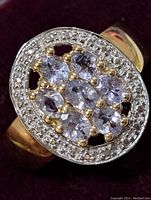 Close-up photo of the sterling silver tanzanite cluster ring showing detail of stones and setting.